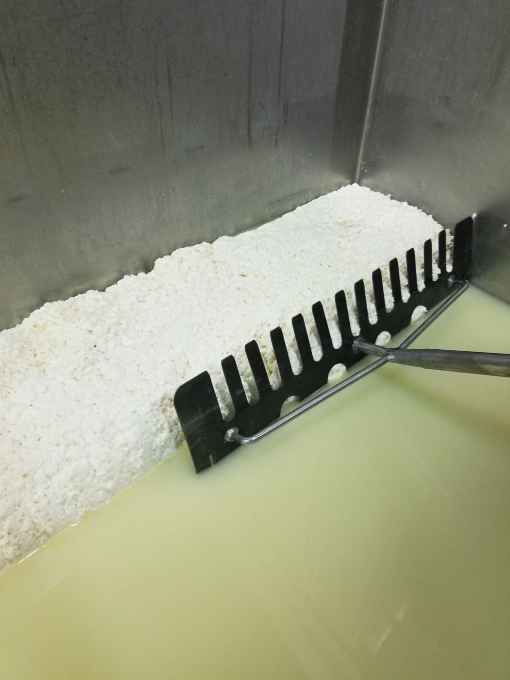 Whey being drained.